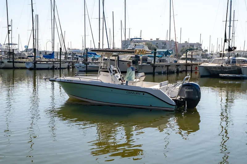 The Image of 2007 Century 2200 Center Console boat in marina, surrounded by sailboats. - 0