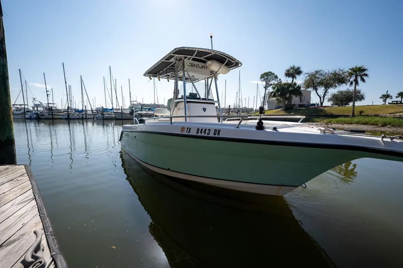 Slide: The Image of 2007 Century 2200 Center Console boat docked in a marina, sunny day, calm water. - 10