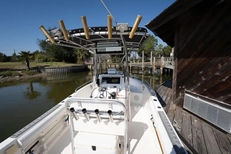 Slide: The Image of 2007 Century 2200 Center Console boat docked by wooden structure, sunny day. - 16