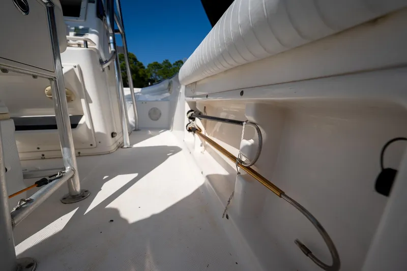Slide: The Image of 2007 Century 2200 Center Console boat interior with fishing rod holders and seating. - 19