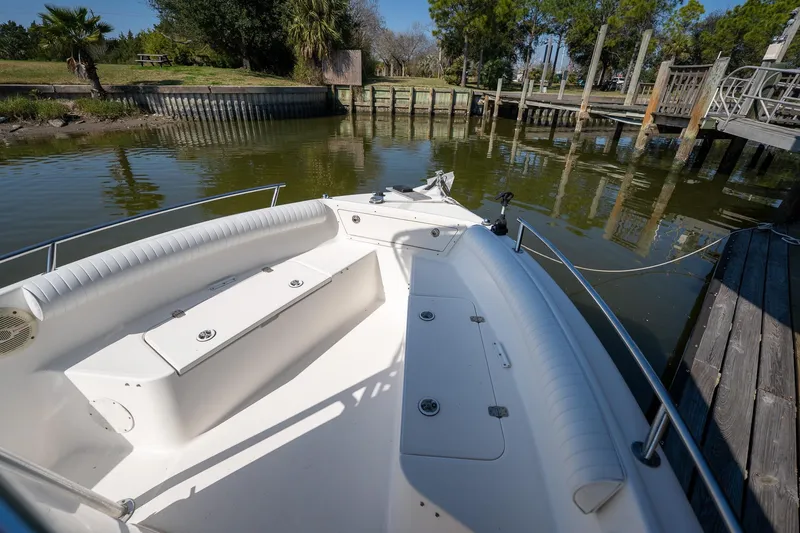 Slide: The Image of 2007 Century 2200 Center Console boat docked by a scenic waterfront. - 23