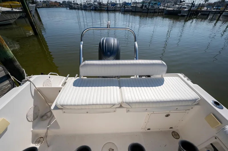 Slide: The Image of 2007 Century 2200 Center Console boat with white seating, docked at a marina. - 26