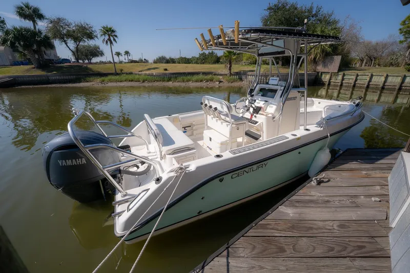 Slide: The Image of 2007 Century 2200 Center Console boat docked with Yamaha engine, surrounded by lush greenery. - 29
