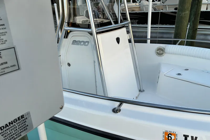 Slide: The Image of 2004 Century 2200 Center Console boat, white interior, docked at marina. - 39