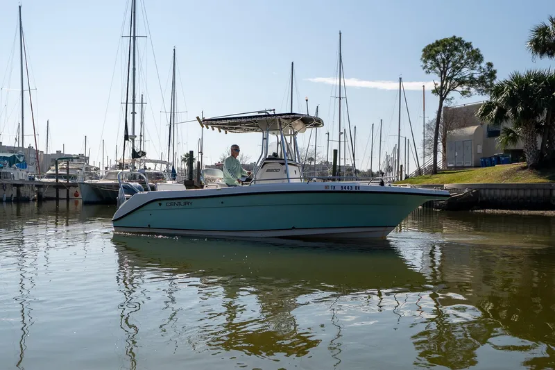 Slide: The Image of 2007 Century 2200 Center Console boat in marina, calm water, clear sky. - 4