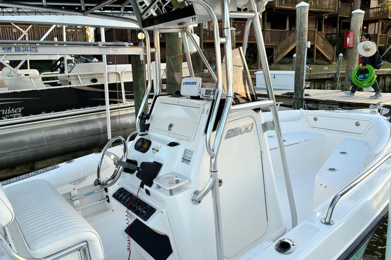 Slide: The Image of 2004 Century 2200 Center Console boat docked, featuring sleek design and modern controls. - 40