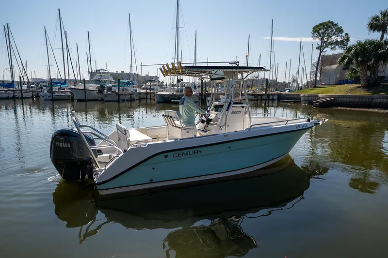Slide: The Image of 2007 Century 2200 Center Console boat in marina, featuring Yamaha outboard motor. - 5
