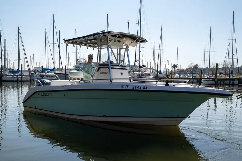 Slide: The Image of 2007 Century 2200 Center Console boat docked in marina with sailboats in background. - 7