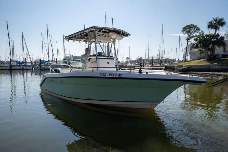 Slide: The Image of 2007 Century 2200 Center Console boat docked in marina, calm water, clear sky. - 8