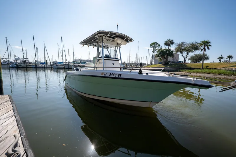 Slide: The Image of 2007 Century 2200 Center Console boat docked in a marina with sailboats. - 9