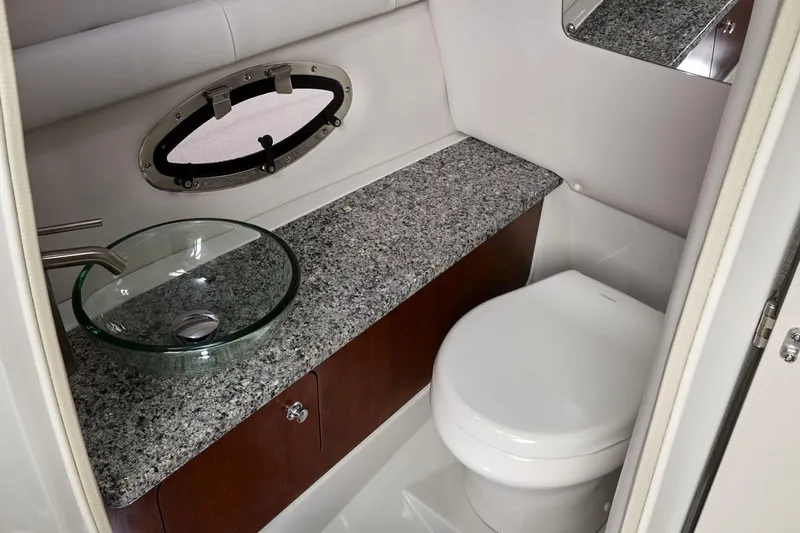 Slide: The Image of Manufacturer Provided Image: 2025 Crownline 278 SS boat bathroom with granite countertop and modern fixtures. - 7