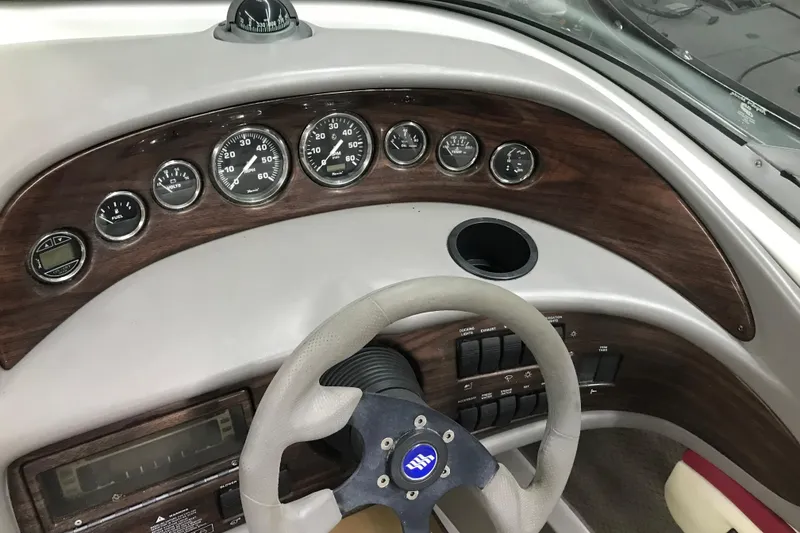 Slide: The Image of Dashboard of 2001 Four Winns 210 Horizon boat with gauges and steering wheel. - 14