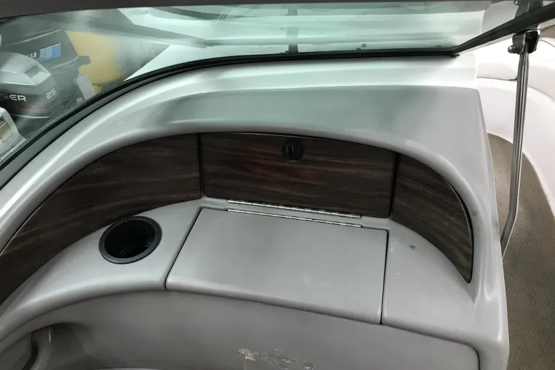 Slide: The Image of 2001 Four Winns 210 Horizon boat interior with wood paneling and cup holder. - 15