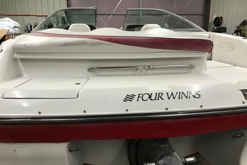 Slide: The Image of 2001 Four Winns 210 Horizon boat, rear view in a garage setting. - 21