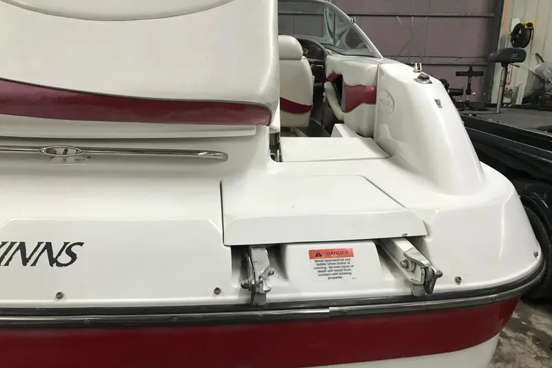 Slide: The Image of 2001 Four Winns 210 Horizon boat, rear view with seating and warning label. - 8