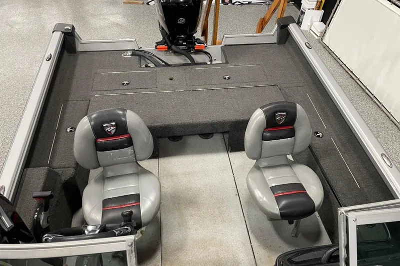 Slide: The Image of 2015 Triton 178 DV boat interior with two seats and motor. - 10