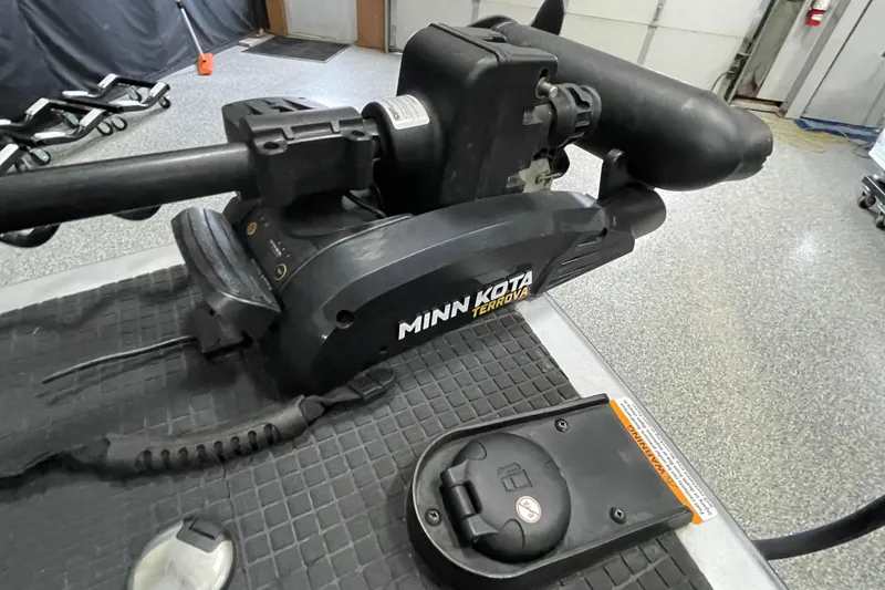 Slide: The Image of Minn Kota Terrova motor on 2015 Triton 178 DV boat in garage setting. - 20