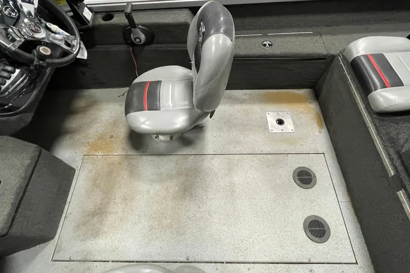 Slide: The Image of 2015 Triton 178 DV boat interior with gray seating and steering wheel. - 22