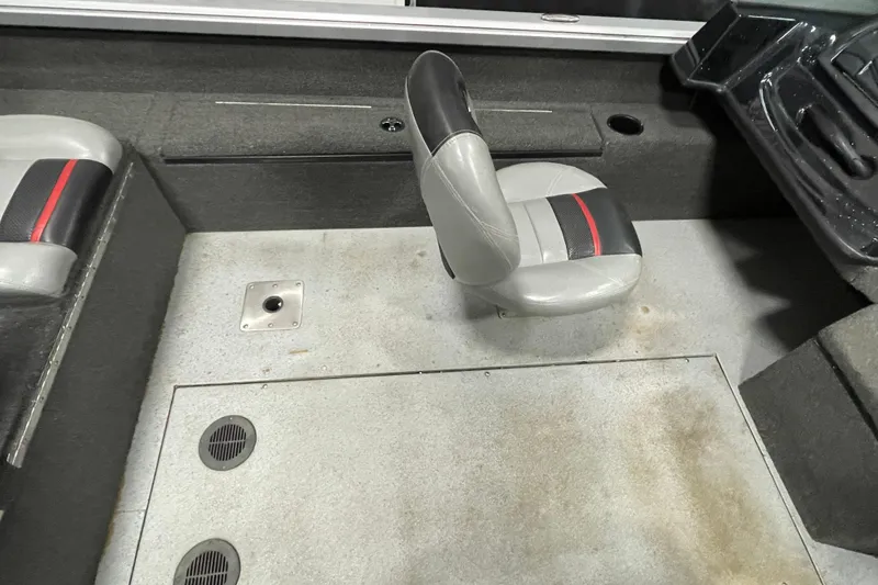 Slide: The Image of Interior of 2015 Triton 178 DV boat with gray seating and carpeted flooring. - 23