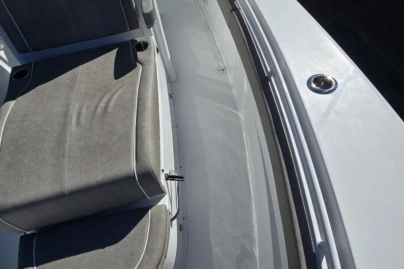 Slide: The Image of 2026 Sea Hunt Ultra 285 Coffin Box boat interior with cushioned seating and cup holders. - 12