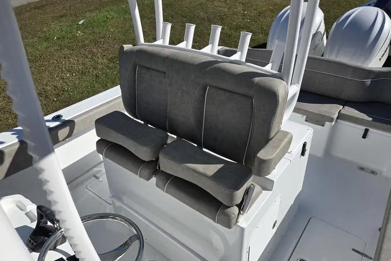 Slide: The Image of 2026 Sea Hunt Ultra 285 Coffin Box boat interior with cushioned seating and rod holders. - 21