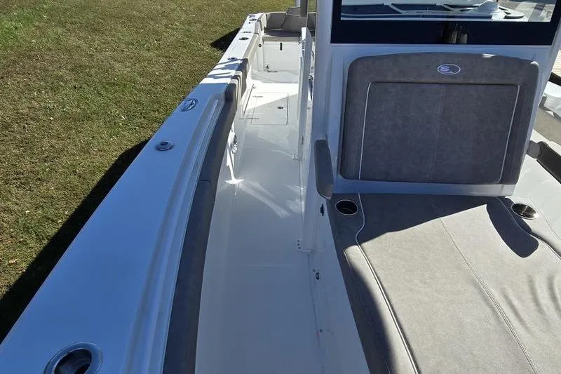 Slide: The Image of 2026 Sea Hunt Ultra 285 Coffin Box boat interior with seating and deck view. - 22