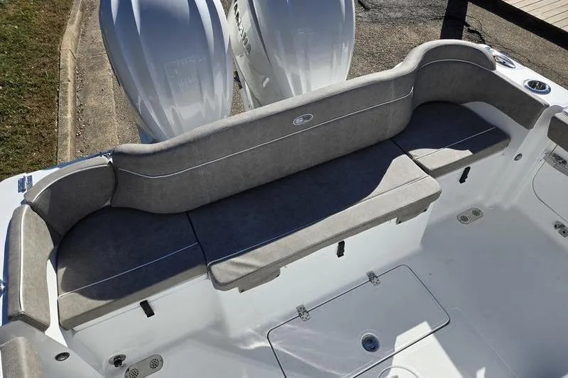 Slide: The Image of 2026 Sea Hunt Ultra 285 Coffin Box boat interior with cushioned seating and dual engines. - 31