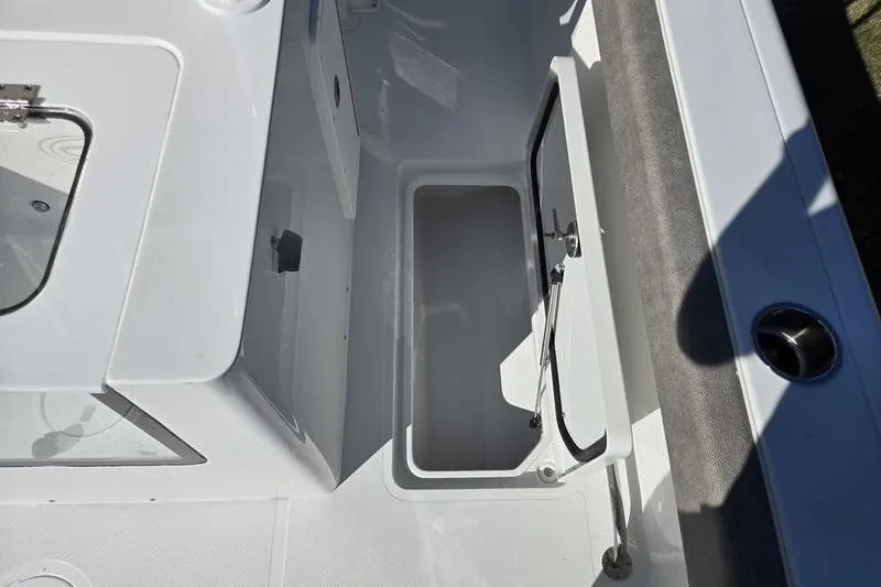 Slide: The Image of 2026 Sea Hunt Ultra 285 Coffin Box interior storage compartment. - 7