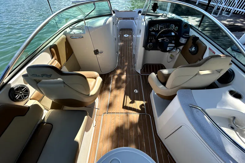 Slide: The Image of 2007 Sea Ray 260 Sundeck interior with seating and steering console on the water. - 13