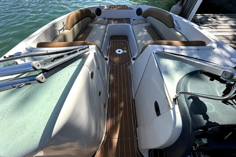 Slide: The Image of 2007 Sea Ray 260 Sundeck interior with brown seating and wooden deck. - 16