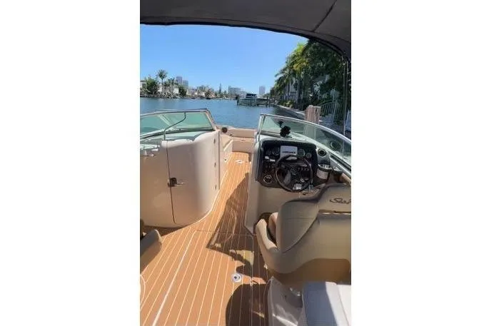 Slide: The Image of 2007 Sea Ray 260 Sundeck boat, "The Black Diamond," on water with scenic background. - 2