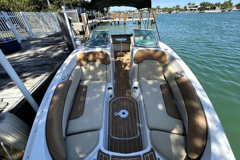 Slide: The Image of 2007 Sea Ray 260 Sundeck boat docked by a serene waterfront. - 20
