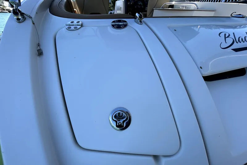 Slide: The Image of 2007 Sea Ray 260 Sundeck boat deck with storage compartment and sleek design. - 31