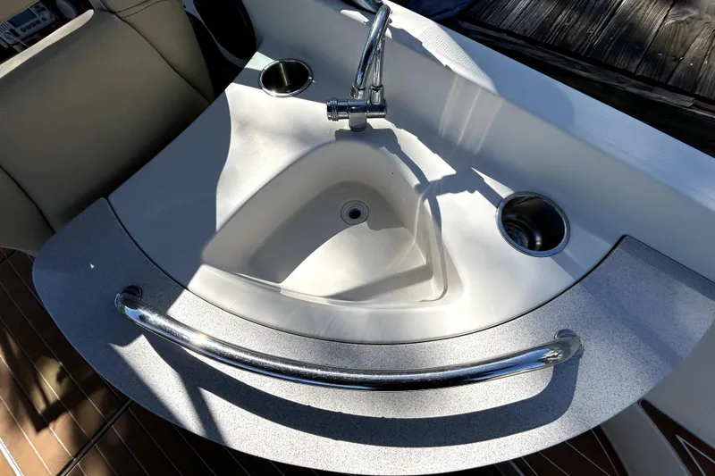 Slide: The Image of 2007 Sea Ray 260 Sundeck boat sink with faucet and cup holders. - 37