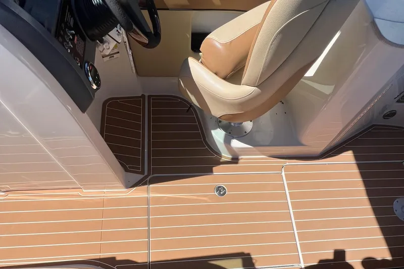 Slide: The Image of 2007 Sea Ray 260 Sundeck boat on water, with cityscape background. - 5