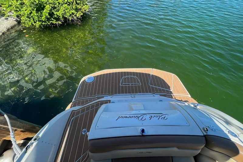 Slide: The Image of 2007 Sea Ray 260 Sundeck boat named "The Black Diamond" on a serene waterway. - 6