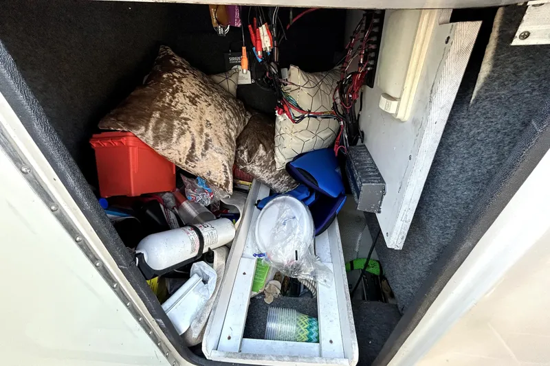 Slide: The Image of Storage compartment of a 2007 Sea Ray 260 Sundeck with various items and equipment. - 61
