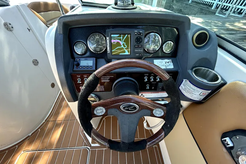 Slide: The Image of Dashboard of a 2007 Sea Ray 260 Sundeck boat with steering wheel and navigation instruments. - 70