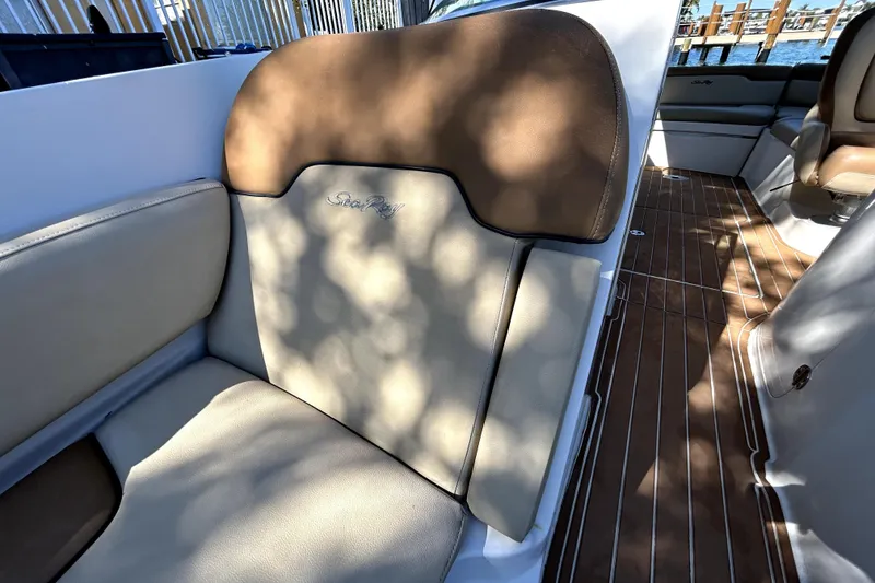 Slide: The Image of 2007 Sea Ray 260 Sundeck interior with beige and brown seating, wooden flooring. - 71