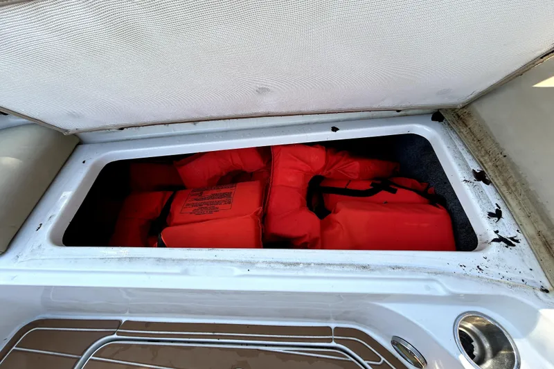Slide: The Image of Storage compartment with life jackets on a 2007 Sea Ray 260 Sundeck boat. - 74