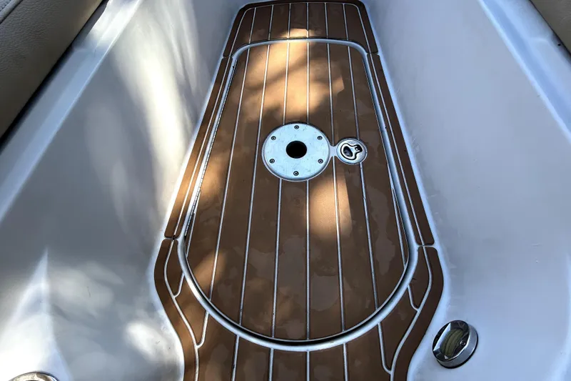 Slide: The Image of 2007 Sea Ray 260 Sundeck boat deck with wood finish and metal fittings. - 76