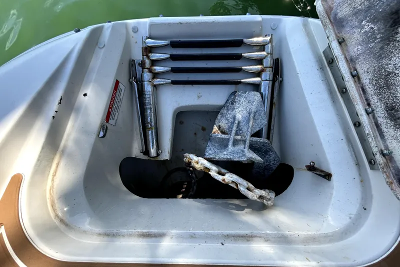 Slide: The Image of Open storage compartment on 2007 Sea Ray 260 Sundeck with anchor and accessories. - 84