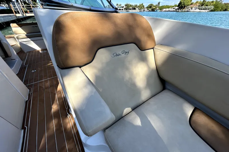 Slide: The Image of 2007 Sea Ray 260 Sundeck interior with tan leather seating and wooden flooring. - 89