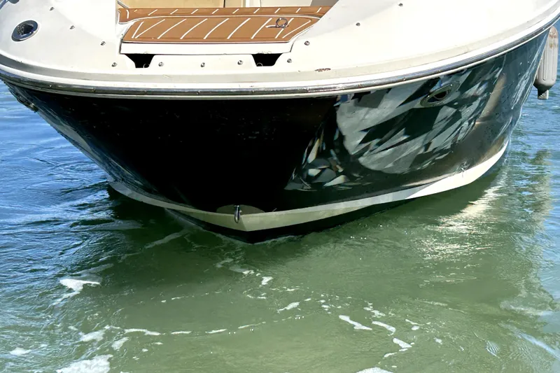 Slide: The Image of 2007 Sea Ray 260 Sundeck boat on water, front view. - 90