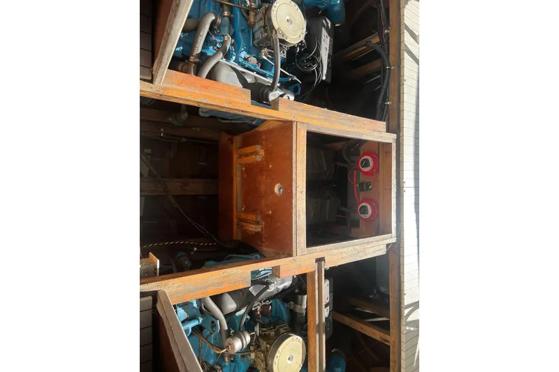 Slide: The Image of Engine compartment of a 1987 Skiff Craft 31' Runabout, showcasing dual engines and wooden framework. - 12