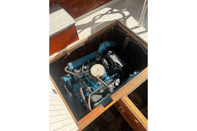 Slide: The Image of Engine compartment of a 1987 Skiff Craft 31' Runabout, showcasing a blue marine engine. - 13
