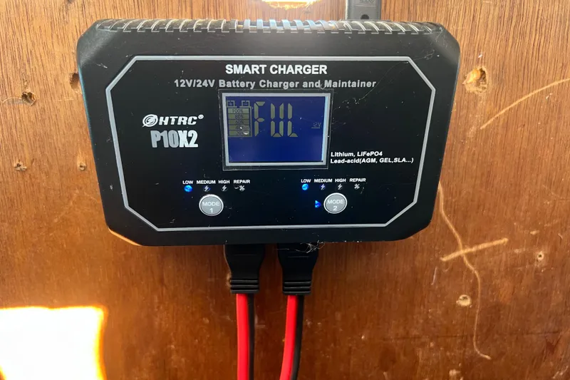Slide: The Image of HTRC P10X2 smart charger on 1987 Skiff Craft 31' Runabout, mounted on wooden surface. - 15
