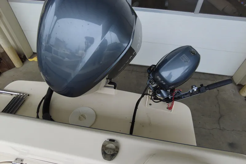 Slide: The Image of 2016 Grady-White Seafarer 228 boat with dual outboard motors in a garage setting. - 10