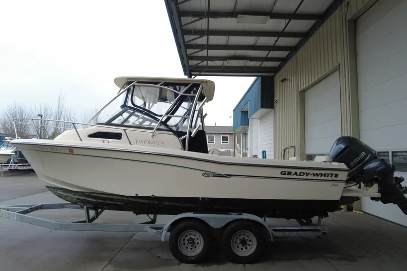 Slide: The Image of 2016 Grady-White Seafarer 228 boat on trailer, parked in covered area. - 2