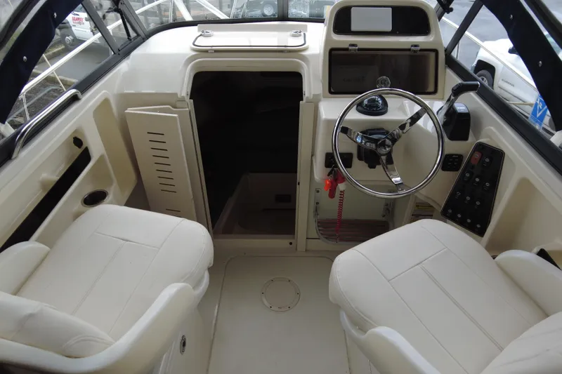 Slide: The Image of 2016 Grady-White Seafarer 228 boat interior with steering wheel and seating. - 4